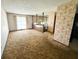 Large living room featuring unique wallpaper, carpet, and stairs to another level at 906 Hemlock St, Shelbyville, IN 46176