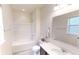 Bright bathroom with tub and shower combination, white vanity and large mirror at 9404 Crystal River Dr, Indianapolis, IN 46240