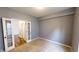 Cozy bedroom featuring neutral carpet, gray walls, and french doors to hall at 9404 Crystal River Dr, Indianapolis, IN 46240