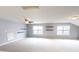 Bright bonus room with neutral carpet, gray walls, shelves, and windows at 9404 Crystal River Dr, Indianapolis, IN 46240