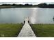 Dock and stone path leading to the lake, offering access for boating and water activities at 9404 Crystal River Dr, Indianapolis, IN 46240