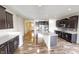 A modern kitchen boasts an island with a white countertop, stainless steel appliances, and dark cabinets at 9404 Crystal River Dr, Indianapolis, IN 46240