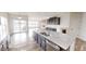 A large kitchen with an island and stainless steel appliances that opens to a living room with a fireplace at 9404 Crystal River Dr, Indianapolis, IN 46240