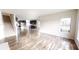 Open concept living room showcasing hardwood floors and a view of the modern kitchen at 9404 Crystal River Dr, Indianapolis, IN 46240
