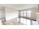 Bright living room with wood flooring, large windows, and stone fireplace, overlooking the lake at 9404 Crystal River Dr, Indianapolis, IN 46240