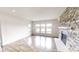 Sun-filled living room with wood floors and fireplace, offering stunning views of the lake outside the window at 9404 Crystal River Dr, Indianapolis, IN 46240