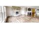 The living room has wood floors, fireplace, and large windows offering lots of natural light in the room at 9404 Crystal River Dr, Indianapolis, IN 46240