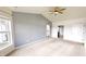 Comfortable bedroom featuring a ceiling fan, neutral walls, and an ensuite bathroom at 9404 Crystal River Dr, Indianapolis, IN 46240