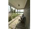Cozy screened porch with an indoor/outdoor rug, seating, and views of the lake at 9404 Crystal River Dr, Indianapolis, IN 46240