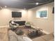 Cozy basement space with recessed lighting, window, sectional sofa, accent chairs, and modern furnishings at 955 Dorman St, Indianapolis, IN 46202