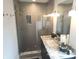 Modern bathroom featuring a glass-enclosed shower with stylish tiling and a vanity with a granite countertop at 955 Dorman St, Indianapolis, IN 46202