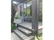 Inviting front porch with comfortable seating, stylish planters, and modern black framing around the windows and doors at 955 Dorman St, Indianapolis, IN 46202