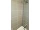 Shower with light gray tiled walls and modern fixtures, offering a clean and refreshing space at 955 Dorman St, Indianapolis, IN 46202