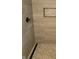 Modern shower featuring tiled walls, mosaic tile flooring, built-in niche, and sleek hardware at 955 Dorman St, Indianapolis, IN 46202