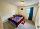 A bright bedroom features grey carpets, light walls, and a window with green curtains at 9621 Gemini Dr, Indianapolis, IN 46229