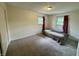 Cozy bedroom with neutral carpet and a single bed, illuminated by natural light at 9621 Gemini Dr, Indianapolis, IN 46229