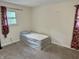 Cozy bedroom featuring neutral walls, grey carpeting, and minimal furniture, providing a blank canvas at 9621 Gemini Dr, Indianapolis, IN 46229
