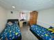 Spacious bedroom with twin beds, wardrobe, desk and Pokemon themed linen, perfect for siblings or sleepovers at 9621 Gemini Dr, Indianapolis, IN 46229