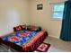 Bright bedroom with a window and comfortable bed with floral sheets and a matching rug at 9621 Gemini Dr, Indianapolis, IN 46229