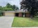 Charming one-story brick home with a well-maintained lawn and concrete driveway at 9621 Gemini Dr, Indianapolis, IN 46229
