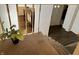 View of stairway showing carpet and access to the kitchen and front door at 9621 Gemini Dr, Indianapolis, IN 46229