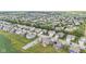 An aerial shot displays a residential area with orderly houses complemented by green spaces and a nearby pond at 9986 Gallop Ln, Fishers, IN 46040