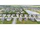 An aerial view captures a residential area nestled near a pond, showcasing a serene community at 9986 Gallop Ln, Fishers, IN 46040
