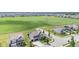 This aerial shot showcases a community with a green space, meticulously designed homes, and well-kept lawns at 9986 Gallop Ln, Fishers, IN 46040