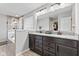 Double vanity bathroom with granite countertops, dark cabinets and bright lights at 9986 Gallop Ln, Fishers, IN 46040
