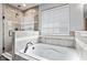 Luxurious bathroom featuring a soaking tub, separate shower, and stylish tile work at 9986 Gallop Ln, Fishers, IN 46040