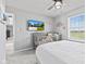 Bright bedroom with ceiling fan, grey walls, and decor with a crib for an infant at 9986 Gallop Ln, Fishers, IN 46040