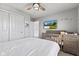 Calming bedroom with a ceiling fan, natural light, grey walls, and infant furnishings at 9986 Gallop Ln, Fishers, IN 46040