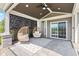 Cozy covered patio featuring wicker chairs, geometric rug, and inviting outdoor ambiance at 9986 Gallop Ln, Fishers, IN 46040
