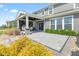 Charming covered patio with wicker swing chairs and view of the well-manicured landscaping at 9986 Gallop Ln, Fishers, IN 46040