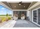 Stylish covered patio with ceiling fan, privacy screen, and modern furniture at 9986 Gallop Ln, Fishers, IN 46040