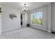 Dining room featuring gray walls, carpet, and a modern chandelier at 9986 Gallop Ln, Fishers, IN 46040