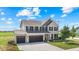 Spacious two-story home featuring a three-car garage and a well-maintained lawn at 9986 Gallop Ln, Fishers, IN 46040