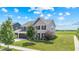 Attractive two-story house showcasing a three-car garage and verdant landscaping at 9986 Gallop Ln, Fishers, IN 46040