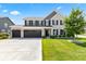 Beautiful two-story home boasts a three-car garage and manicured lawn at 9986 Gallop Ln, Fishers, IN 46040