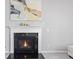Elegant fireplace with white mantel and black surround, complemented by modern decor at 9986 Gallop Ln, Fishers, IN 46040