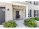 Inviting front porch with brick accents and well-manicured landscaping at 9986 Gallop Ln, Fishers, IN 46040