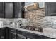Close-up of a stovetop with backsplash and overhead vent in a modern gourmet kitchen at 9986 Gallop Ln, Fishers, IN 46040
