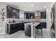 Modern kitchen with dark cabinetry, stainless steel appliances, and a functional center island at 9986 Gallop Ln, Fishers, IN 46040