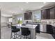 Spacious kitchen with large island, bar stool seating, and stainless steel dishwasher at 9986 Gallop Ln, Fishers, IN 46040