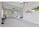 Open concept living space with neutral walls, plush carpet, and a view of the entry way at 9986 Gallop Ln, Fishers, IN 46040