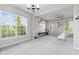 Bright living room with large windows, modern lighting, and neutral decor for comfortable living at 9986 Gallop Ln, Fishers, IN 46040