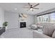 Bright living room with a fireplace, ceiling fan, and comfortable neutral-toned sectional at 9986 Gallop Ln, Fishers, IN 46040