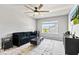 Bright living room with comfortable seating, ceiling fan, large window, and stylish decor at 9986 Gallop Ln, Fishers, IN 46040