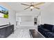 A spacious bonus room with plush seating, stylish decor, and a ceiling fan at 9986 Gallop Ln, Fishers, IN 46040