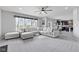 Spacious living area featuring a large sectional, glass coffee table, and big window at 9986 Gallop Ln, Fishers, IN 46040